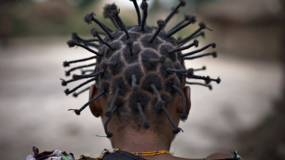 A girl displaced by war wears her hair in a traditional style at Ngalima in northeastern Congo