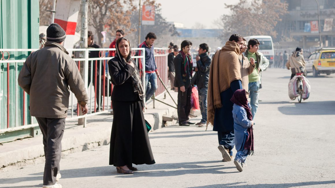 Afghan lady waiting to cross the street in Kabul