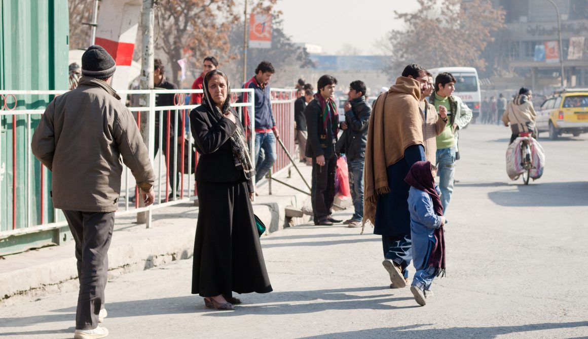 Afghan lady waiting to cross the street in Kabul