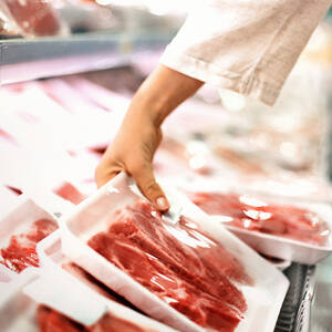 Buying meat at a supermarket.
