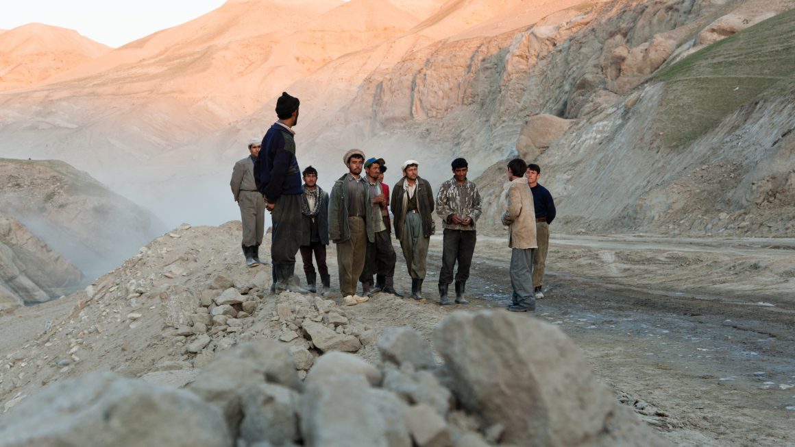 Afghan Laborers waiting for an explosion to clear