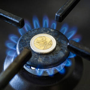 Increase in the cost of the gas bill – euro coin and gas stove turned on