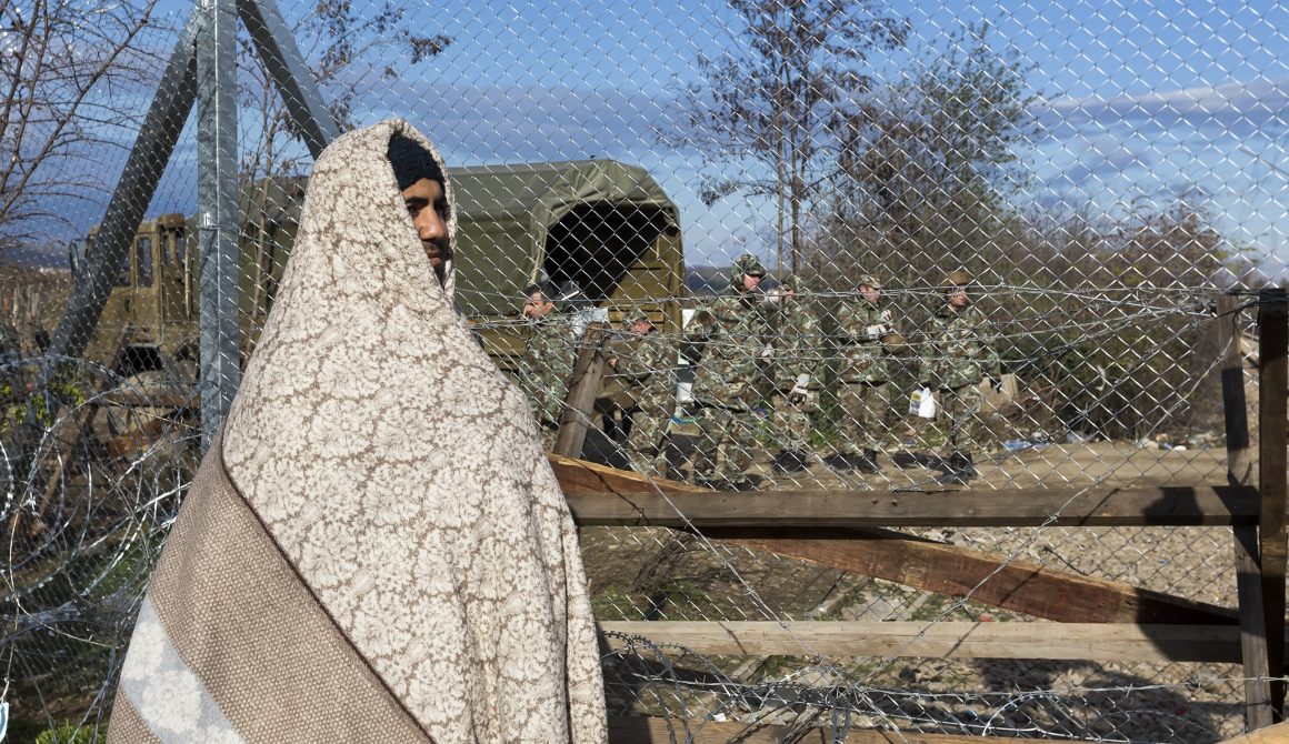 Refugees wait at the border between Greece and FYROM